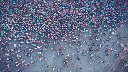 Aerial. People crowd on a city square. Mass gathering of many people in one place. Top view from...