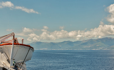 Cruise ship deck with lifeboat and dramatic sky