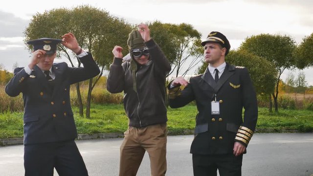 three funny pilots are dancing   joy  positive  aviator