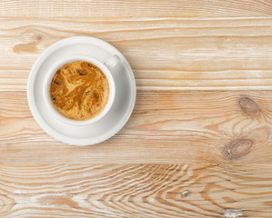Hot coffee cup on brown wooden background top view