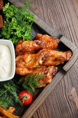 Hot appetizer on a wooden black plate on a dark wooden background. Restaurant menu