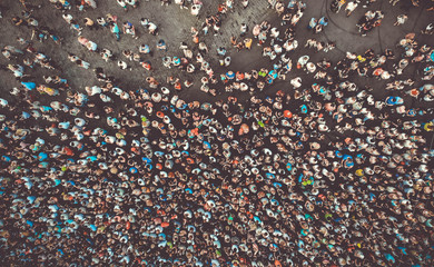 Aerial. People crowd on a city square background. Top view. Toned photo.