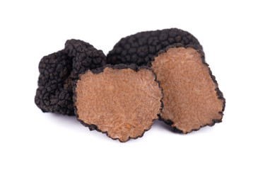 Black truffles isolated on a white background. Fresh sliced truffle. Delicacy exclusive truffle mushroom. Piquant and fragrant French delicacy. Clipping path.