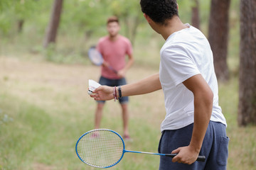 male friends playing recreational badminton