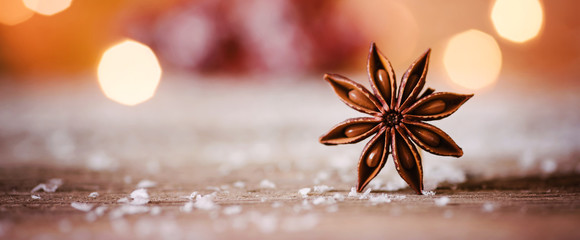 Christmas themed banner or header with a closeup shot of star anise with warm and cozy winter...
