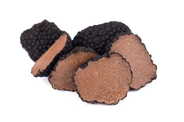 Black truffles isolated on a white background. Fresh sliced truffle. Delicacy exclusive truffle mushroom. Piquant and fragrant French delicacy. Clipping path.
