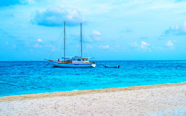 Fototapeta premium Yacht near the pier of a fabulous island in the Maldives.