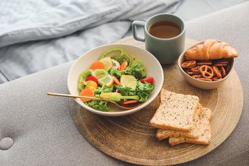 Tray with tasty breakfast in bedroom