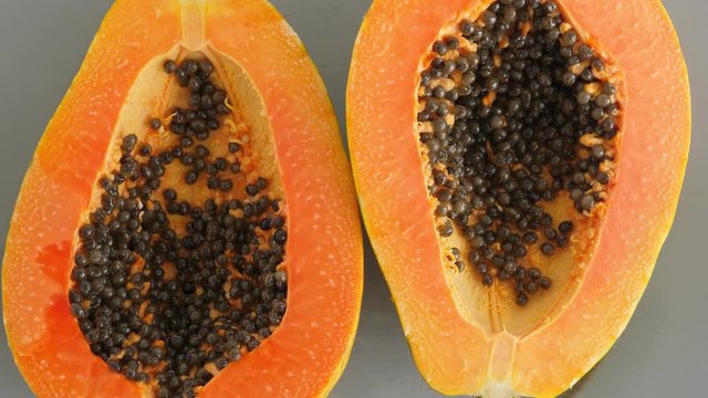 Top view of ripe half cut papaya, flat lay. Rotate