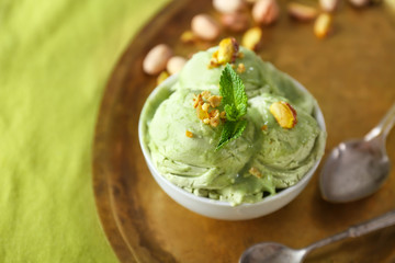 Tray with tasty pistachio ice cream on table, closeup