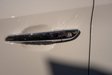 A fragment of the new white crossover model at the time of washing with car shampoo.