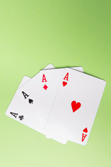 Aces cards on green background from above. Copy space