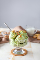 Bowl with tasty pistachio ice cream on table
