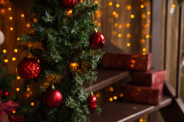 Fototapeta na wymiar Christmas tree decoration with red balls and lights. Holidays concept. Cosy room with eco decor.