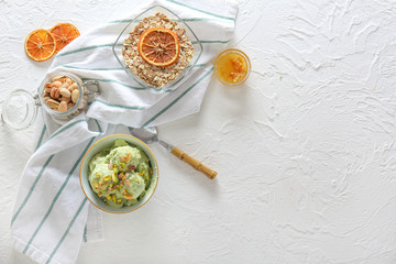 Tasty pistachio ice cream with oat flakes and honey on white background