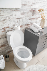 Clean toilet bowl in stylish interior of restroom