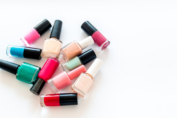 Obraz premium Set of colorful nail polish. Polish bottels on white background top view copy space