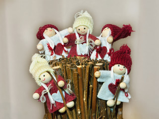 Little christmas elf with braids cap and dress on brushwood