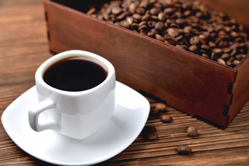 light coffee beans wooden box with coffee, natural wooden background