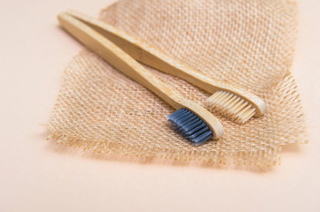 Bamboo tooth brush on light beige natural background
