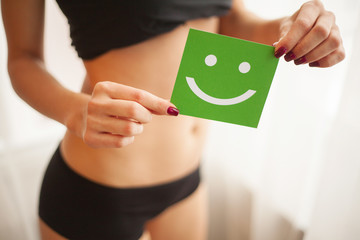 Women Health. Closeup Of Healthy Female With Beautiful Fit Slim Body In Black Panties Holding Green...