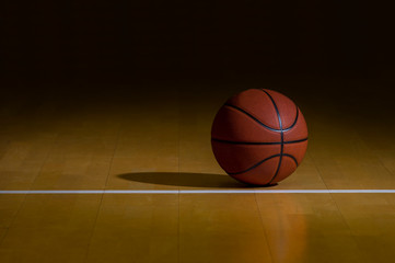 Basketball With Dark Background On A Wood Gym Floor