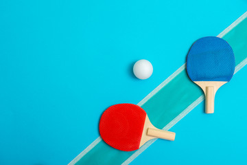 Two rackets for playing table tennis on blue background