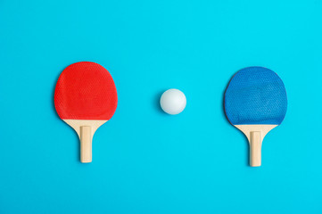 Two rackets for playing table tennis on blue background
