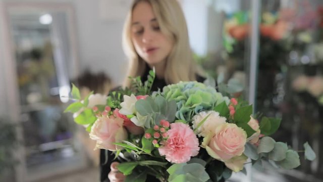 Florist woman make a bouquet of beautiful flowers