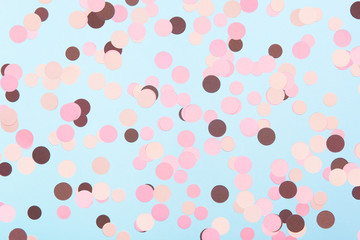 Abstract multicolored confetti on mint blue textured background. Pastel polka dots texture. Flat lay style.