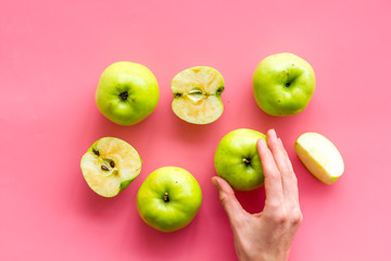 Autumn composition with green apple on pink background top view