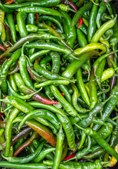 Ripe green chilli pepper for background texture, close-up, top view, copy space for text