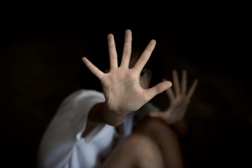 traumatized child showing stop gesture with his hand.
