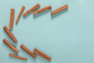 Cinnamon Sticks Isolated On Blue Background with copyspace