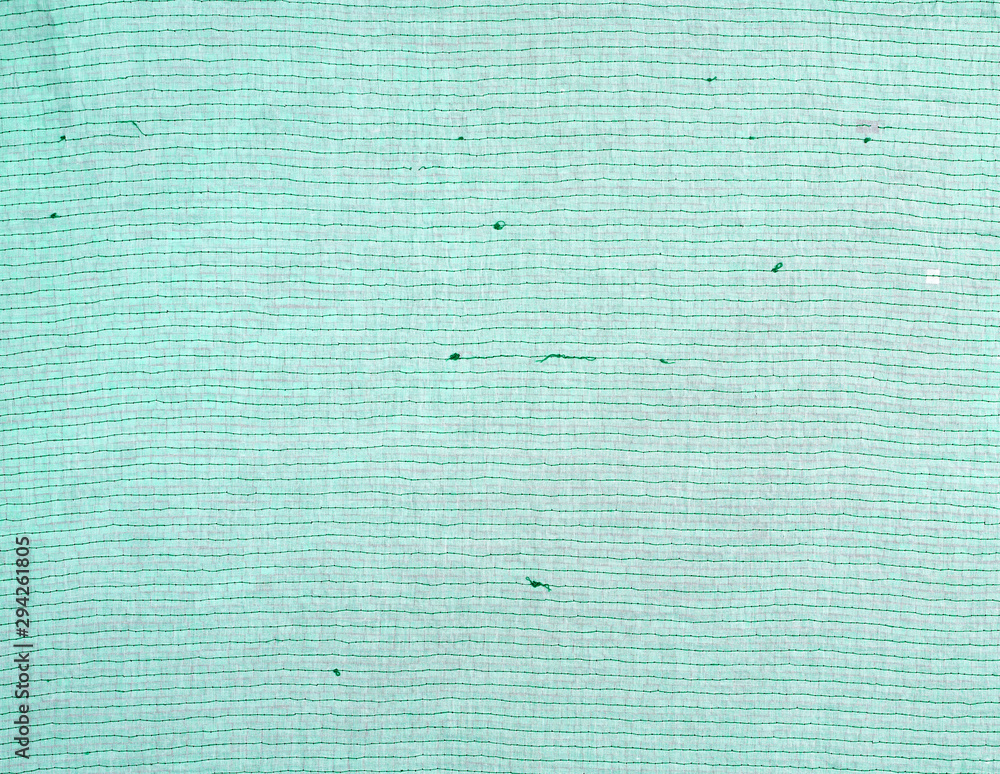 Poster wrong side with a stitch of green thread of fabric with embroidery with multi-colored sequins