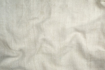 Naklejka premium fragment of a very old linen homespun fabric with waves on the surface