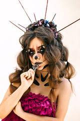 Emotional image for the holiday Halloween, a doll in a pink dress. Makes emotions, drinks champagne, smokes, cross.