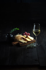 Glass of cold white wine with cheese snack on a wooden. catering menu