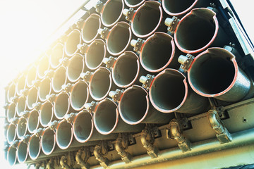 Multiple rocket launcher on military truck in sunlight, close up