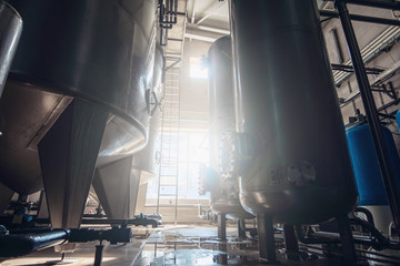 Industrial interior of water plant production. Steel tanks or valves for filtration of water and...