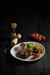 Meat medallion and french fries . catering menu