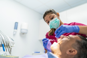 Young Dentist Woman Doing a Check Up to a Patient.