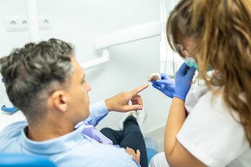 Female Dentist Showing Splint to a Patient.