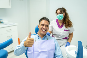 Male Patient at the Dentist Dentist Smiling to the Camera.