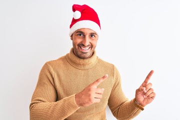Young handsome man wearing christmas and turtleneck sweater over isolated background smiling and...