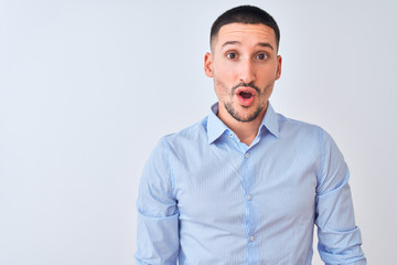 Young handsome business man standing over isolated background afraid and shocked with surprise expression, fear and excited face.