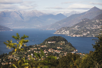 Summer postcard view of Como lake and Bellagio town - famous and popular Italian landmark. Mountains on horizon.