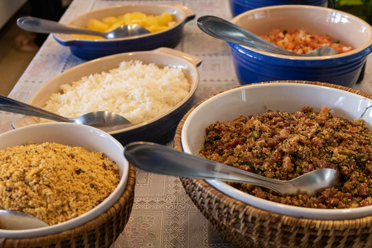 typical brazilian food, rice, beans (feijão tropeiro), farofa, vinaigrette, cooked cassava