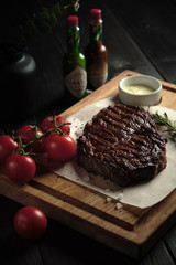 Meat steak on a wooden board. catering menu