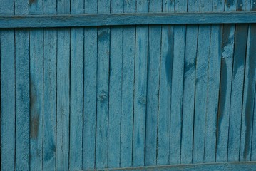 blue wooden background of old thin fence boards